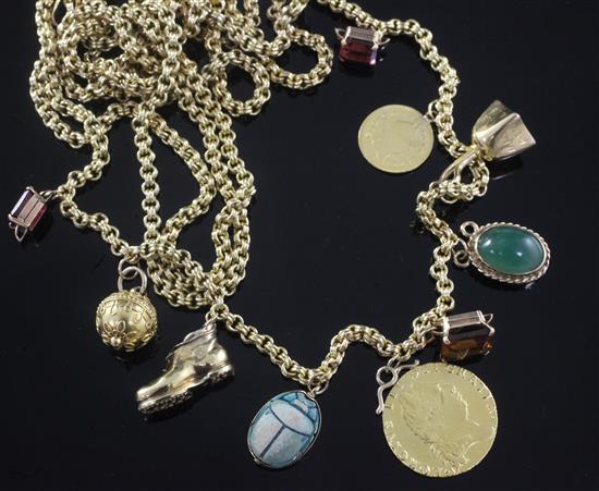 An early 20th century 15ct gold guard chain, hung with various charms including a George III spade guinea, gross 75 grams.